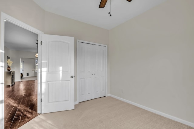 unfurnished bedroom featuring light hardwood / wood-style flooring, a closet, and ceiling fan