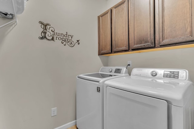 laundry room with cabinets and washing machine and clothes dryer