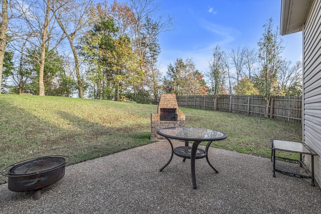 view of patio with an outdoor fireplace