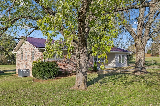 view of home's exterior featuring a yard and central air condition unit