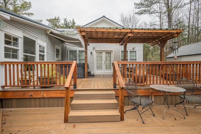 wooden deck featuring a pergola and french doors