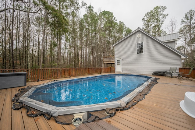 view of swimming pool with a wooden deck