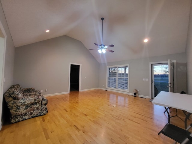 living room featuring light wood-type flooring, ceiling fan, and lofted ceiling