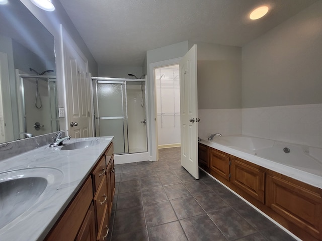 bathroom featuring tile patterned floors, vanity, independent shower and bath, and a textured ceiling