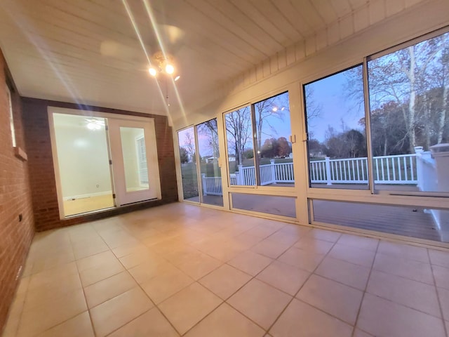 unfurnished sunroom featuring wooden ceiling