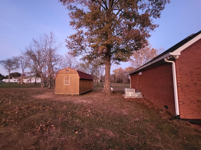 yard at dusk with a storage shed