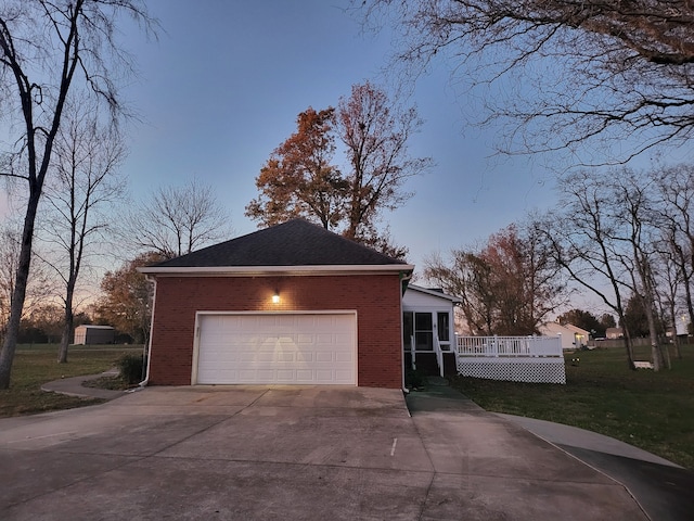 property exterior at dusk featuring a garage and a wooden deck