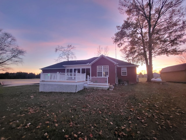 view of front of house featuring a lawn and a wooden deck