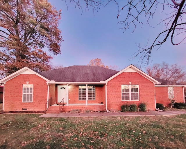 ranch-style home featuring a yard