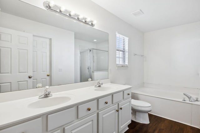 full bathroom with hardwood / wood-style flooring, vanity, toilet, and separate shower and tub