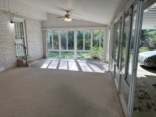 unfurnished sunroom featuring vaulted ceiling and ceiling fan