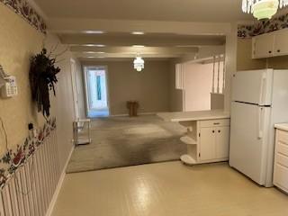 1337 Vanderbilt Rd, Mount Juliet, TN 37122 - kitchen featuring freestanding refrigerator, white cabinetry, light countertops, open shelves, and hanging light fixtures