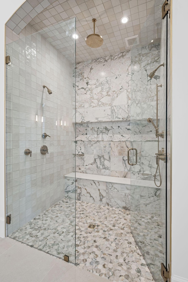 full bathroom featuring a shower stall and visible vents