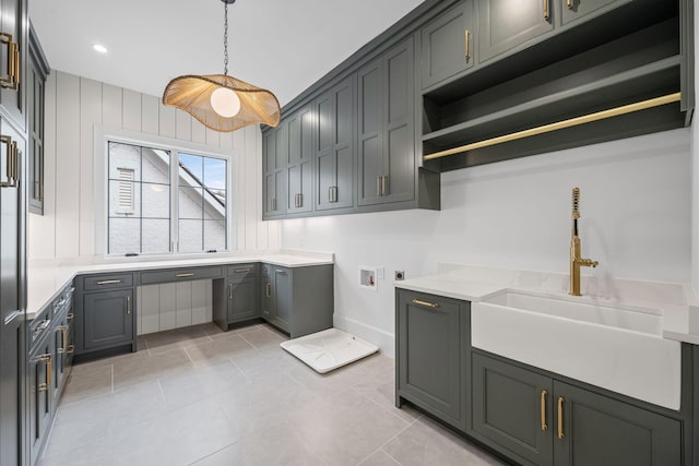 laundry room with light tile patterned flooring, hookup for an electric dryer, washer hookup, a sink, and cabinet space