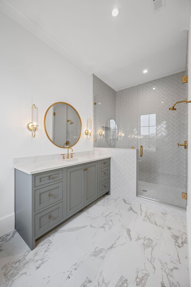 full bathroom featuring a stall shower, marble finish floor, crown molding, vanity, and recessed lighting