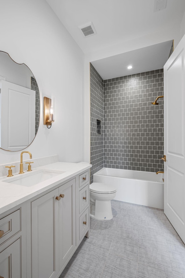 bathroom with  shower combination, visible vents, vanity, and toilet