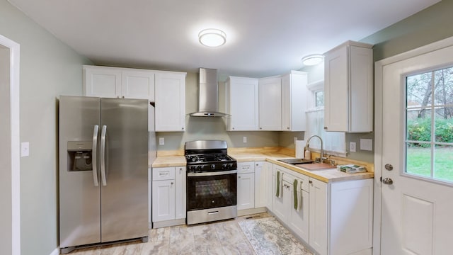 kitchen with white cabinetry, sink, wall chimney exhaust hood, and appliances with stainless steel finishes