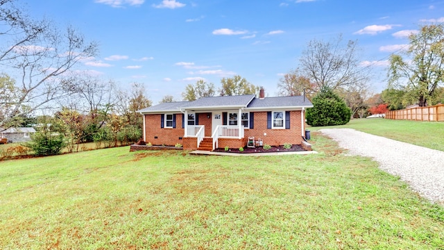 ranch-style home with covered porch and a front lawn