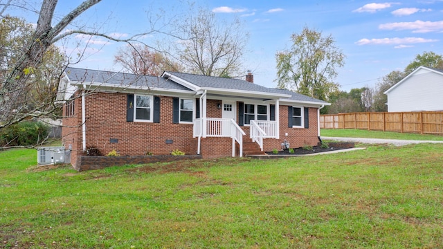 ranch-style home with central AC unit and a front yard