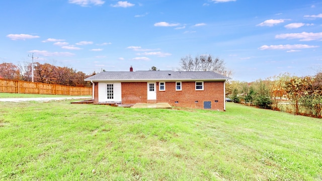 back of house with a yard and a patio