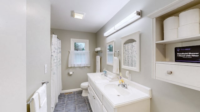 bathroom with tile patterned floors, vanity, and toilet