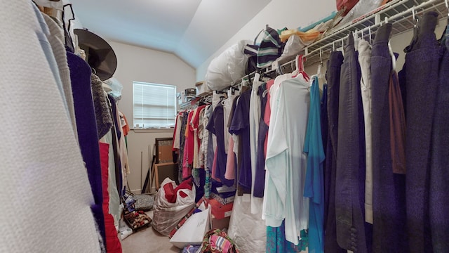 walk in closet with vaulted ceiling