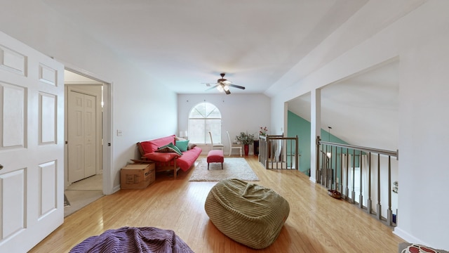 sitting room featuring ceiling fan, wood-type flooring, and vaulted ceiling