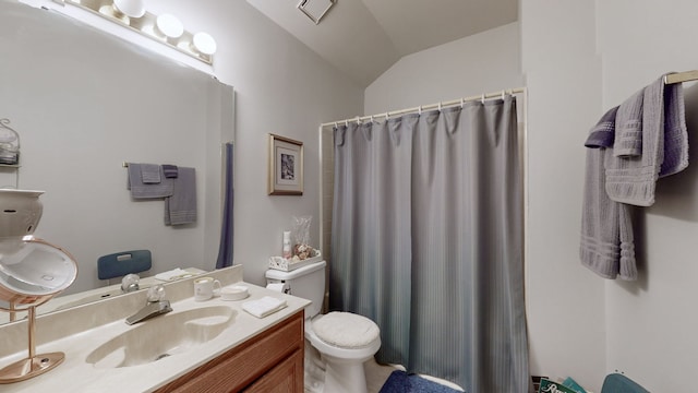 bathroom featuring curtained shower, vanity, vaulted ceiling, and toilet