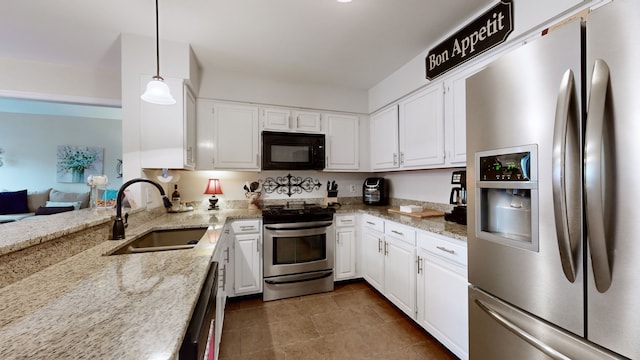 kitchen with white cabinets, sink, light stone countertops, appliances with stainless steel finishes, and decorative light fixtures