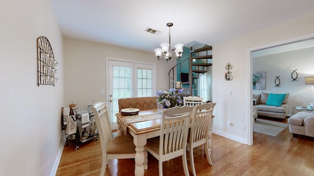 dining area featuring a chandelier and light hardwood / wood-style flooring