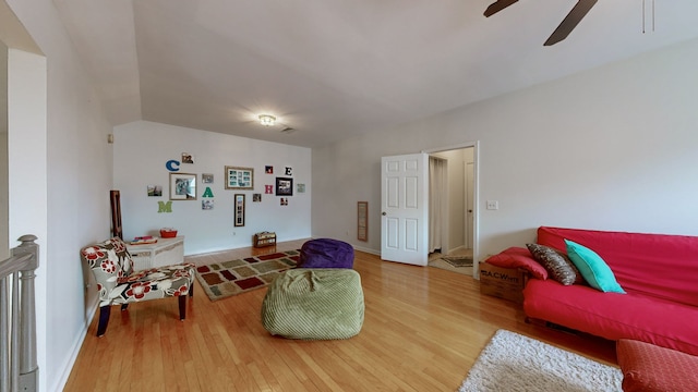 living room featuring hardwood / wood-style flooring and ceiling fan