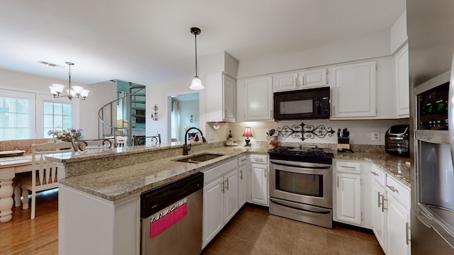 kitchen featuring white cabinetry, sink, stainless steel appliances, an inviting chandelier, and kitchen peninsula