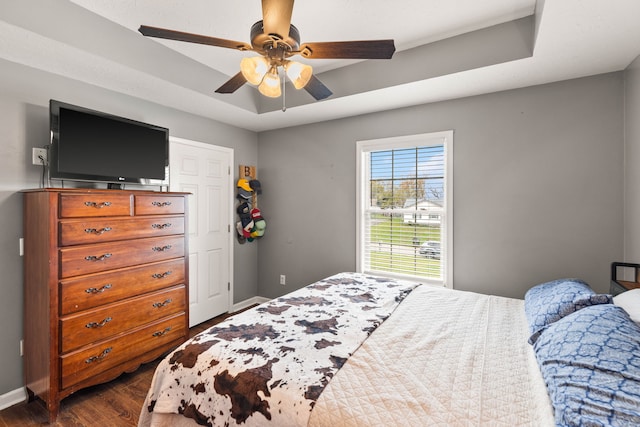 bedroom with dark hardwood / wood-style floors and ceiling fan