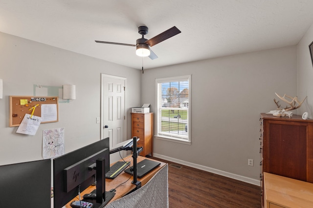 office space featuring ceiling fan and dark hardwood / wood-style flooring