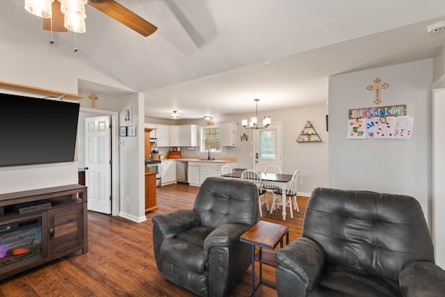 living room with sink, ceiling fan with notable chandelier, dark wood-type flooring, and lofted ceiling