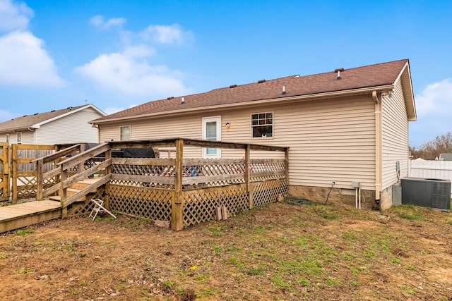 rear view of property featuring central AC and a deck