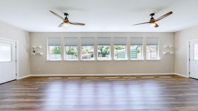 unfurnished living room with dark hardwood / wood-style floors and a wealth of natural light