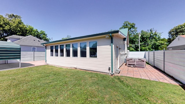 back of house featuring a yard and a patio area