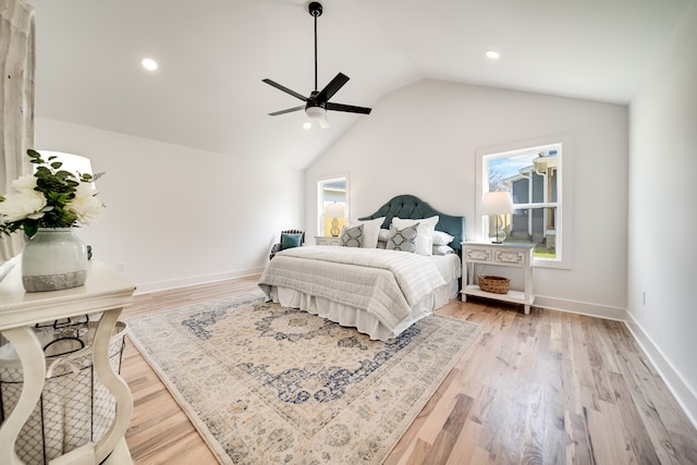 bedroom with light hardwood / wood-style floors, ceiling fan, and lofted ceiling