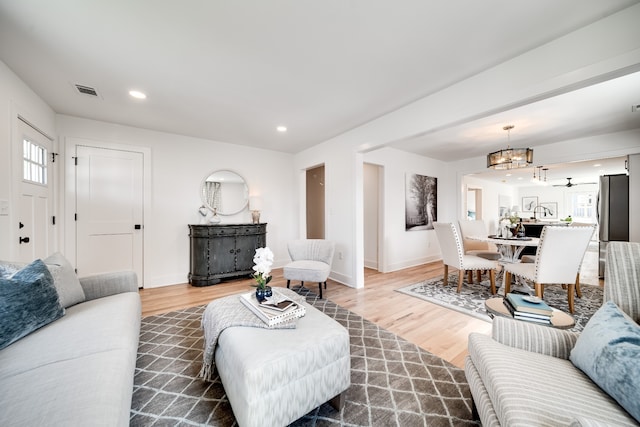 living room with hardwood / wood-style floors and an inviting chandelier