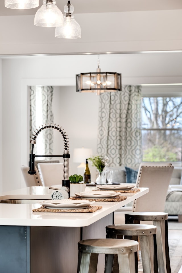 dining area featuring a notable chandelier and sink