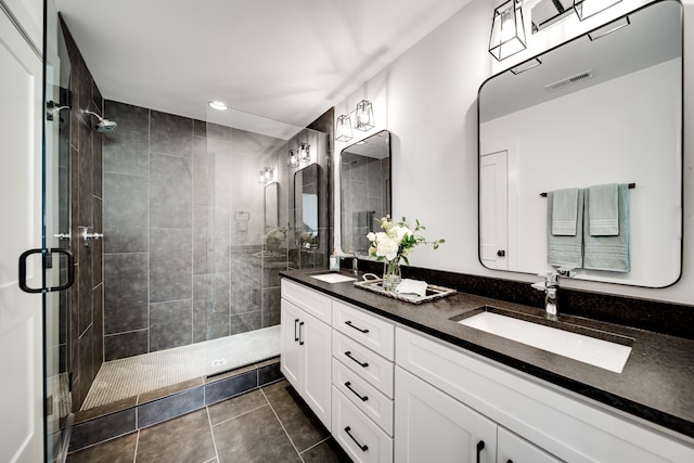 bathroom featuring tile patterned flooring, vanity, and walk in shower