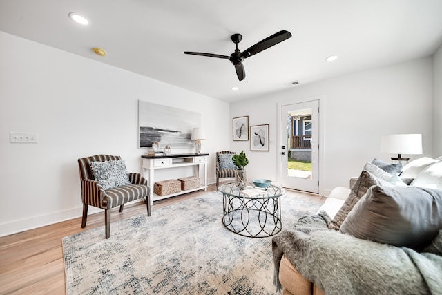 living room featuring light hardwood / wood-style floors and ceiling fan