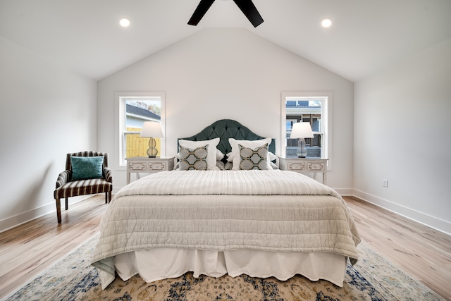 bedroom with multiple windows, ceiling fan, light hardwood / wood-style floors, and vaulted ceiling