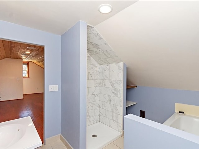 bathroom featuring plus walk in shower, vanity, wood-type flooring, and lofted ceiling