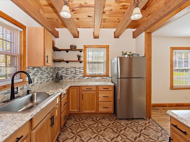 kitchen featuring stainless steel fridge, tasteful backsplash, sink, decorative light fixtures, and beamed ceiling