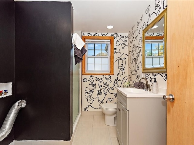 bathroom with tile patterned floors, vanity, an enclosed shower, and toilet