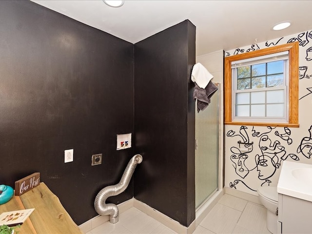 bathroom featuring tile patterned flooring, vanity, toilet, and walk in shower