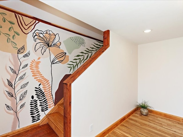 stairway with hardwood / wood-style flooring