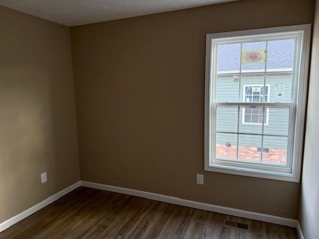 empty room featuring dark wood-type flooring